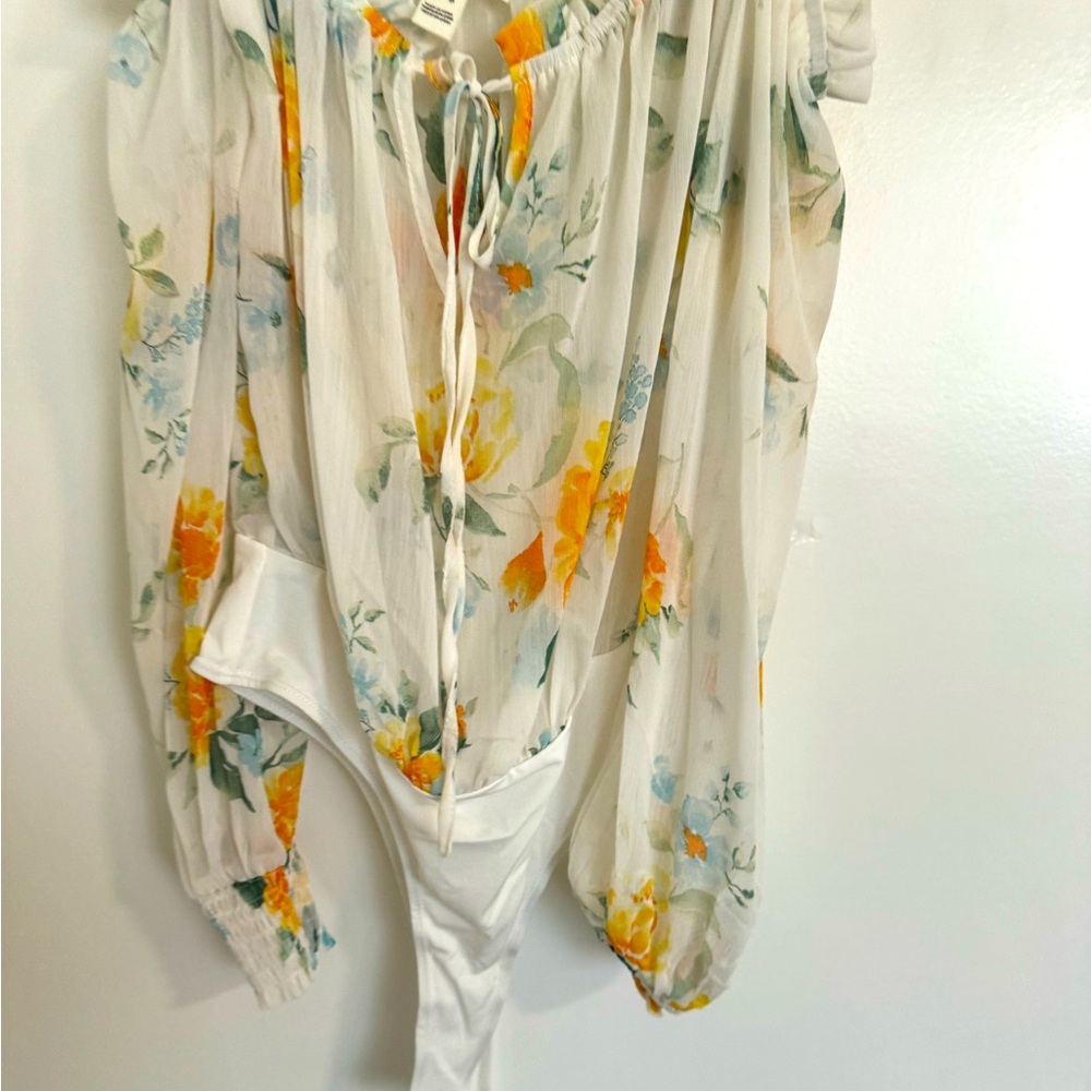 Adorable body suit with sheer floral print top. Never been worn.